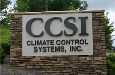 a sign in front of a brick building